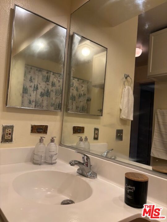 1119 Albany Street, Unit 241 Los Angeles, CA 90015 - Photo 8 of 21 a bathroom with a sink and a mirror