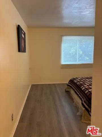 a bedroom with a bed and a mirror