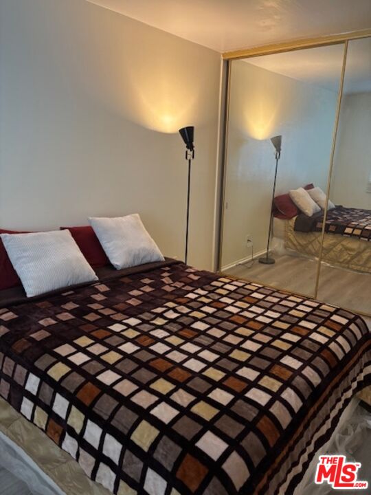 1119 Albany Street, Unit 241 Los Angeles, CA 90015 - Photo 10 of 21 a bedroom with a bed and a mirror