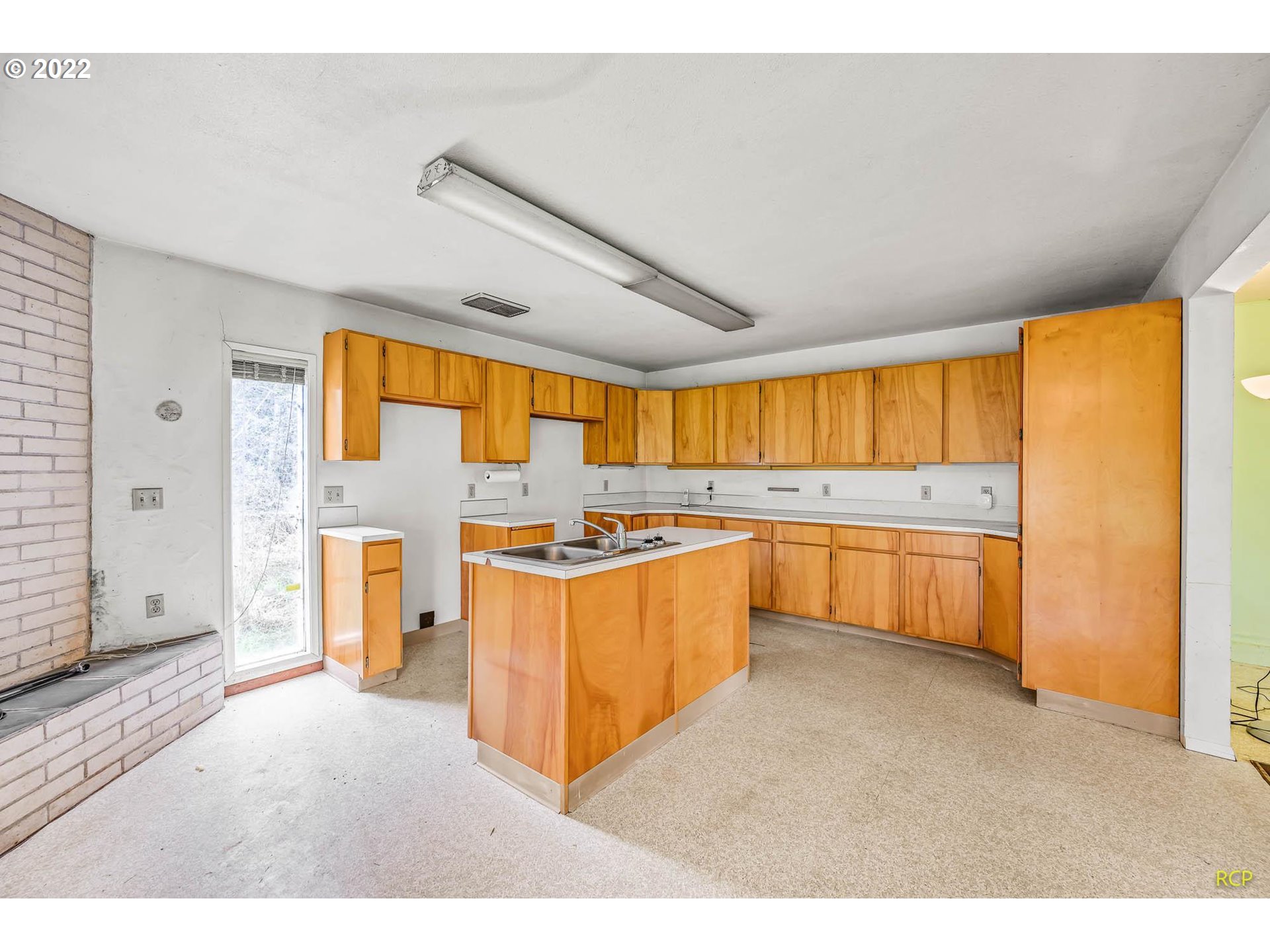24596 Mosier Road Rainier, OR 97048 - Photo 15 of 32 a large white kitchen with a large window
