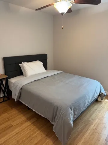 a bedroom with a bed and a night stand