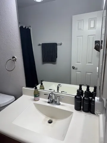 a bathroom with a sink and mirror
