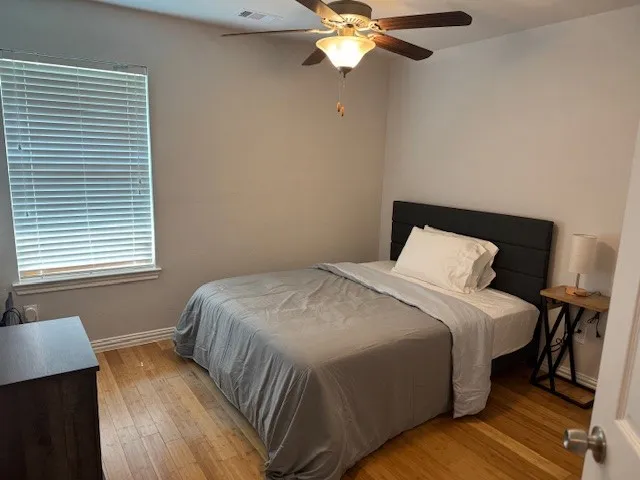 a bedroom with a bed and window