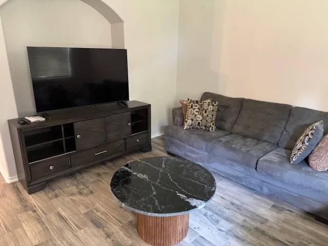 a living room with furniture and a flat screen tv