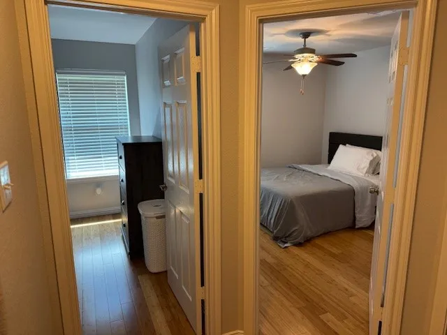 a bedroom with a bed and a flat tv screen on dresser