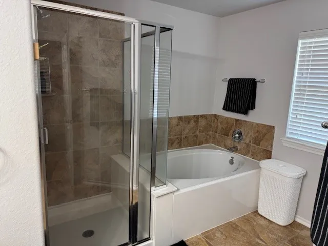 a bathroom with a bathtub and a shower