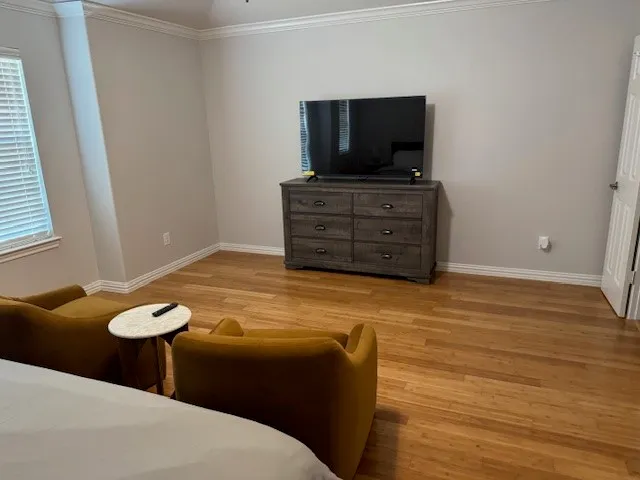 a living room with furniture and flat screen tv