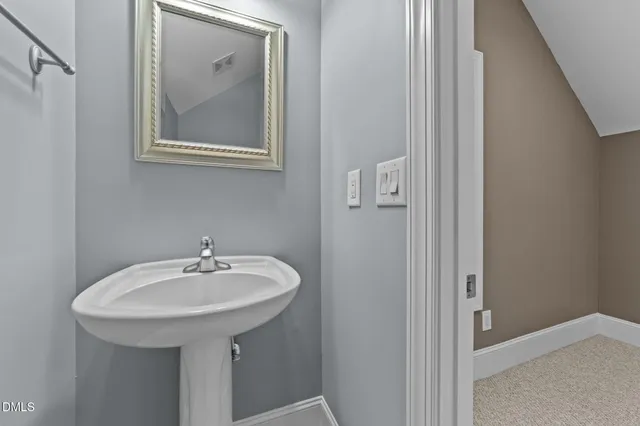 a view of a big room with chandelier fan and windows