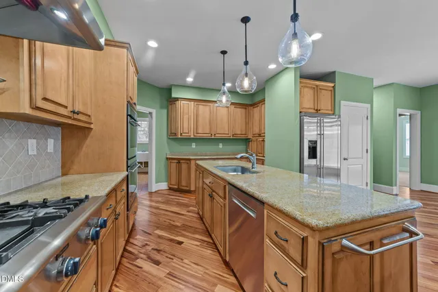 a kitchen with granite countertop a stove and a wooden cabinets