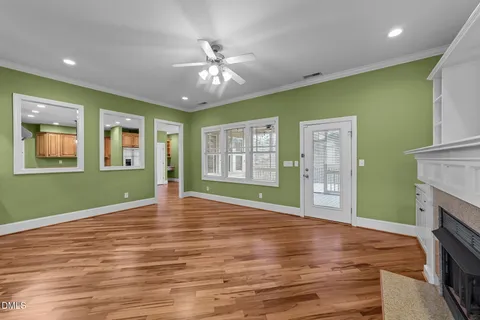 a large kitchen with a lot of counter space and wooden floor