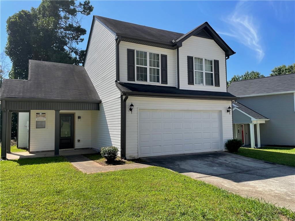 2266 Wingfoot Place Decatur, GA 30035 - Photo 1 of 1 a front view of a house with a yard and garage