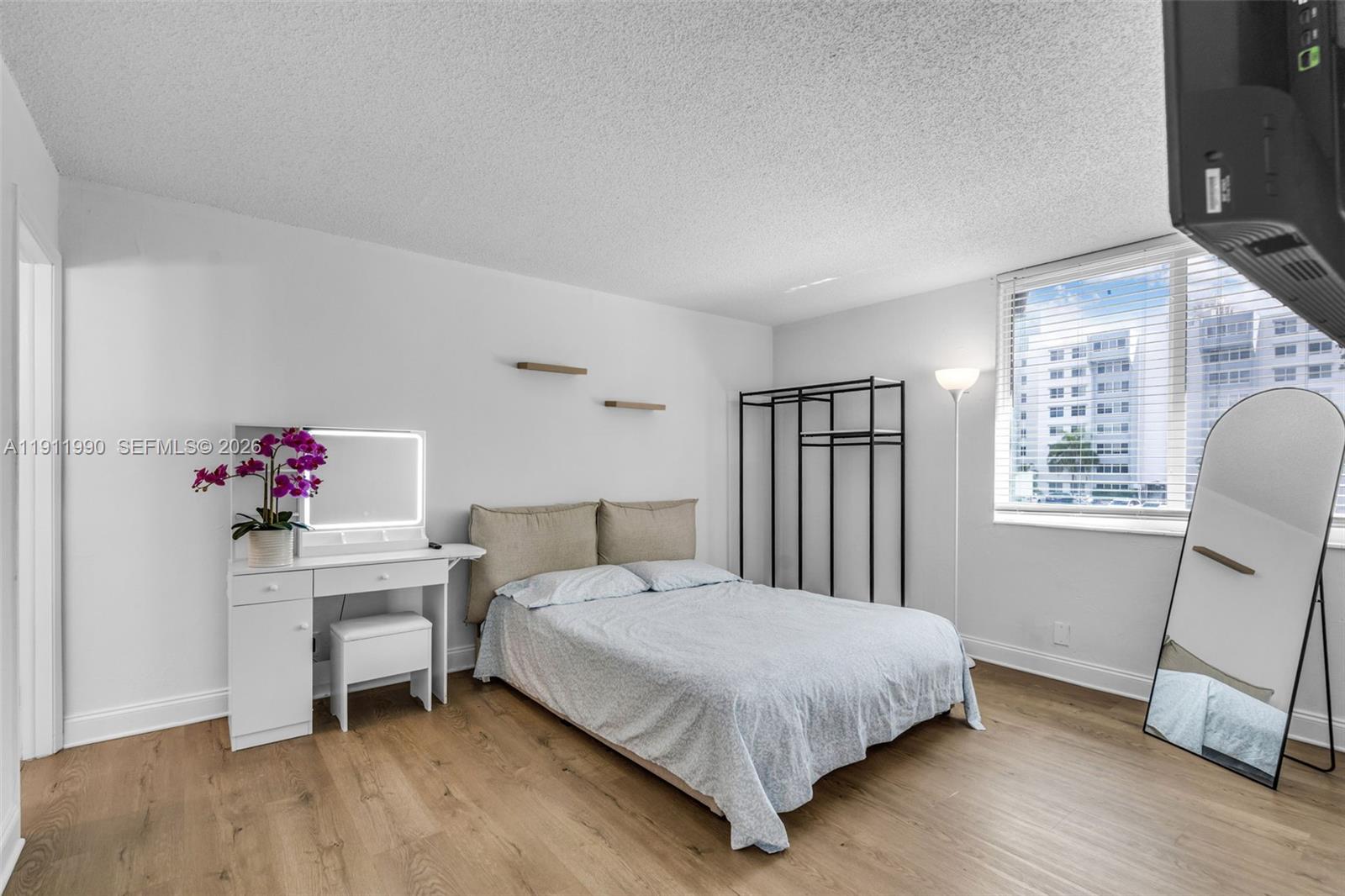 9125 Southwest 77th Avenue, Unit 202 Miami, FL 33156 - Photo 15 of 30 a bedroom with a bed and a window