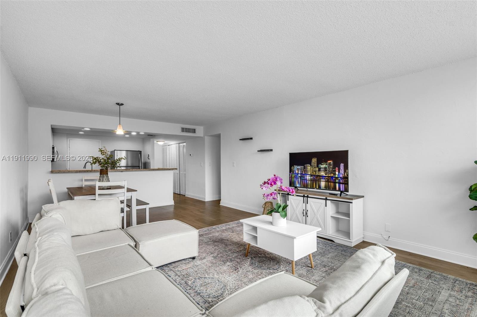 9125 Southwest 77th Avenue, Unit 202 Miami, FL 33156 - Photo 5 of 30 a living room with furniture and a flat screen tv