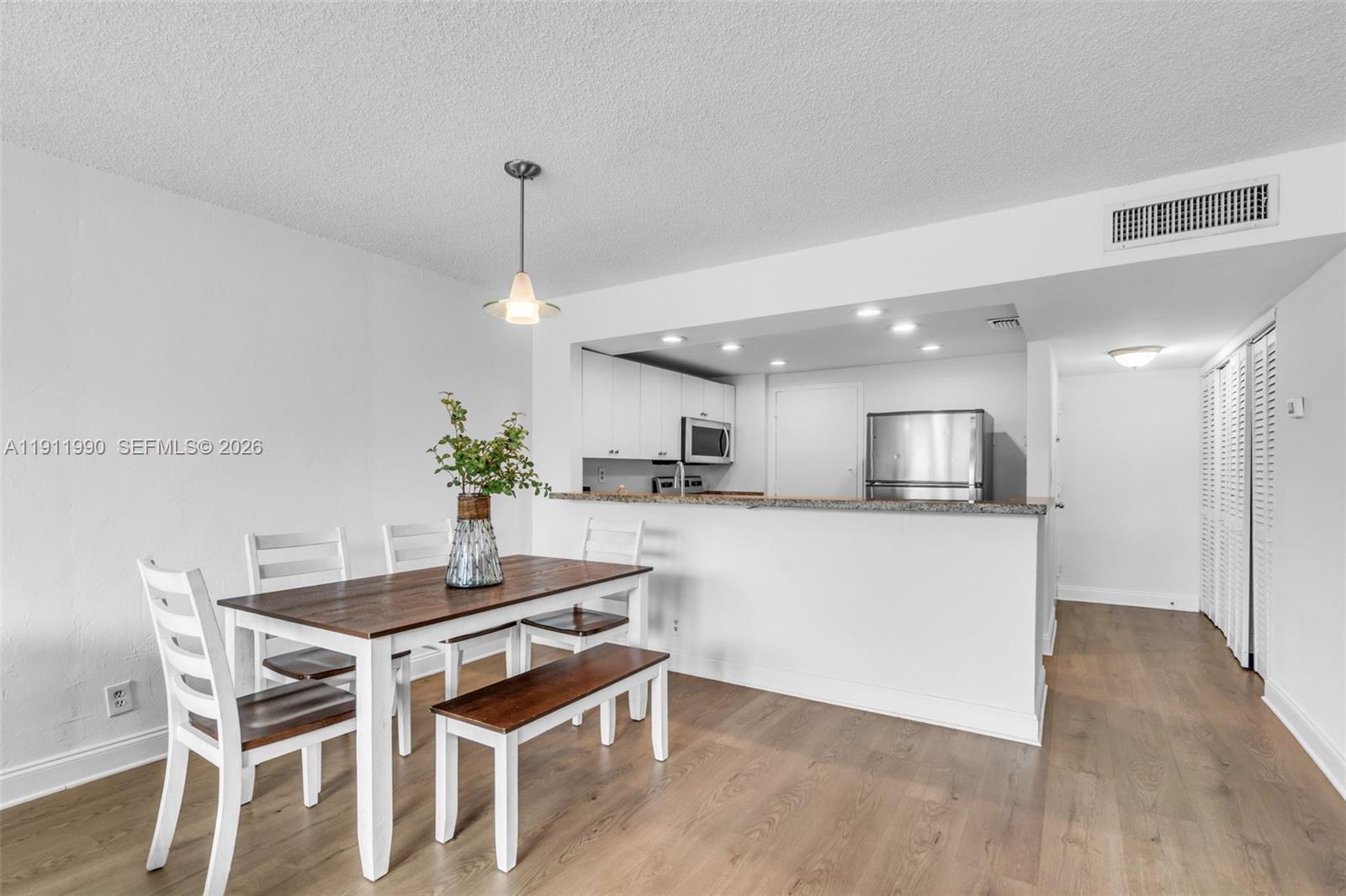 9125 Southwest 77th Avenue, Unit 202 Miami, FL 33156 - Photo 6 of 30 a kitchen with a table and chairs in it