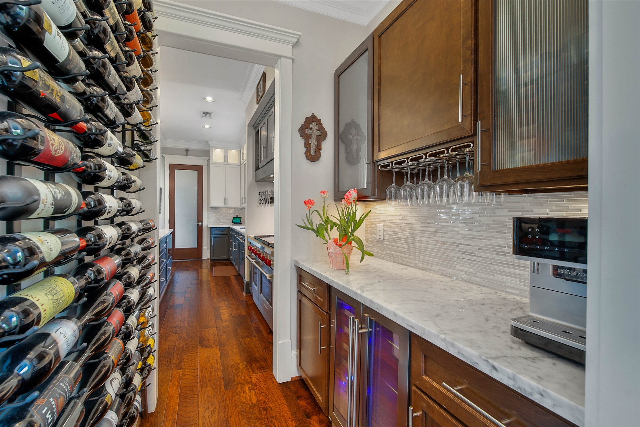 416 West 33rd Street Houston, TX 77018 - Photo 17 of 47 Beautifully appointed Butler’s Pantry featuring marble countertops, custom cabinetry, under-cabinet lighting, beverage refrigeration and built-in wine storage lining the wall—perfectly designed for effortless entertaining between the kitchen and formal dining room.