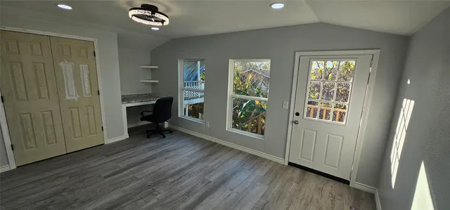 a view of an entryway with wooden floor and windows