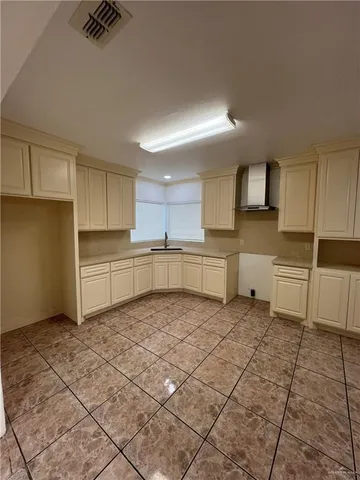a kitchen with a sink a stove and cabinets