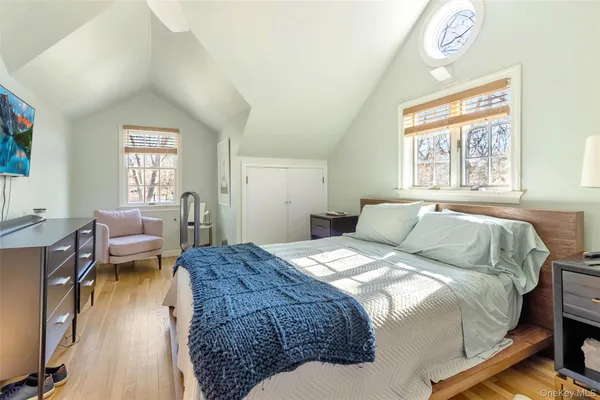a bedroom with a bed and a large window