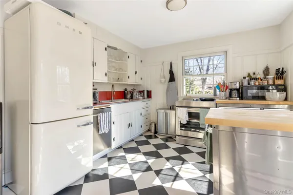 a kitchen with stainless steel appliances a refrigerator sink and cabinets