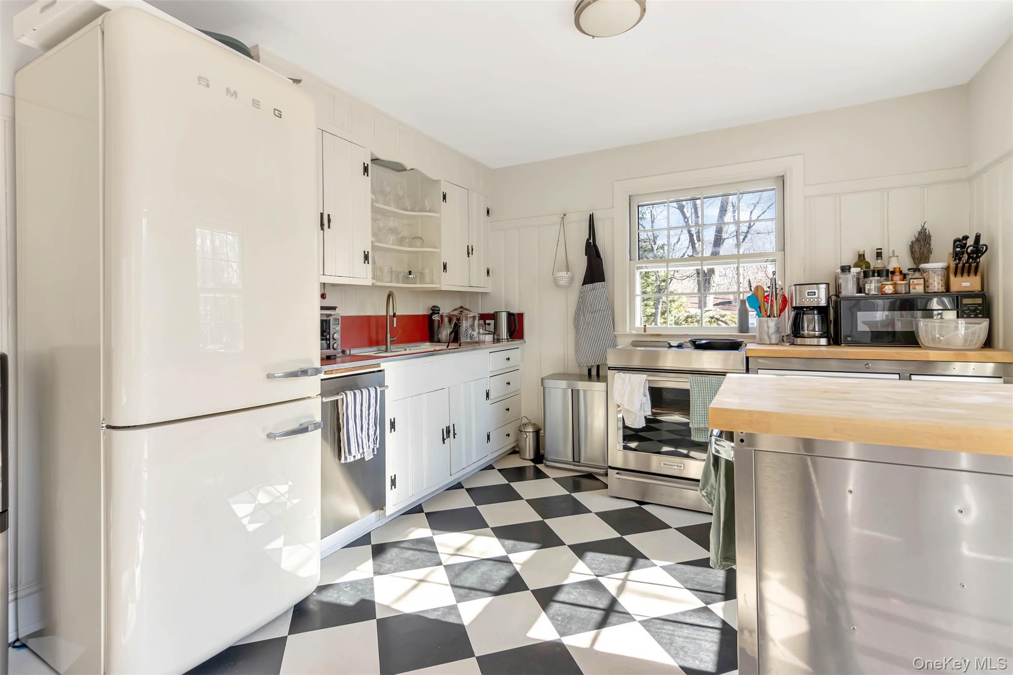 1500 Vanston Road Cutchogue, NY 11935 - Photo 5 of 26 Kitchen with a sink, wood counters, white cabinetry, appliances with stainless steel finishes, and light floors