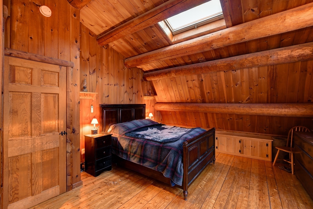 23 Dana Road Petersham, MA 01366 - Photo 16 of 32 a bedroom with a bed and a table