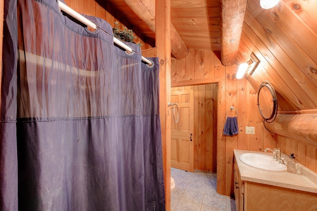 23 Dana Road Petersham, MA 01366 - Photo 17 of 32 a bathroom with a sink a toilet and shower curtain