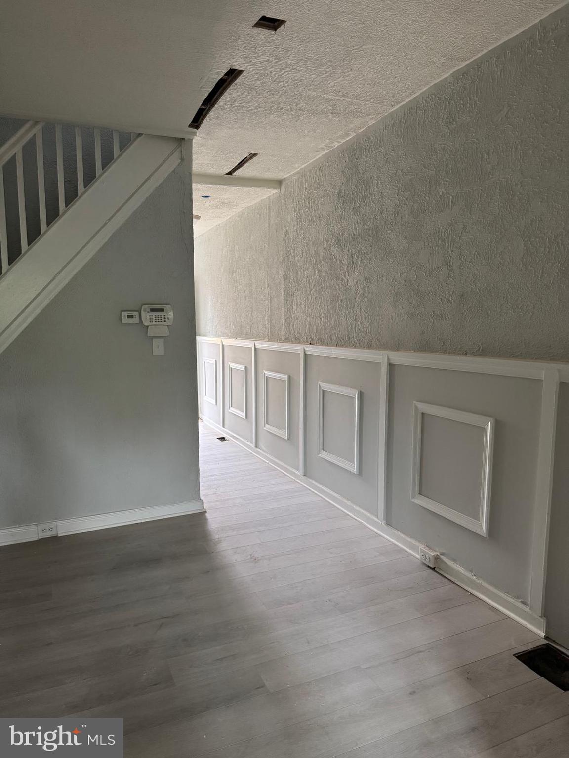 2240 Cedley Street Baltimore, MD 21230 - Photo 11 of 12 a view of an empty room with wooden floor and a window