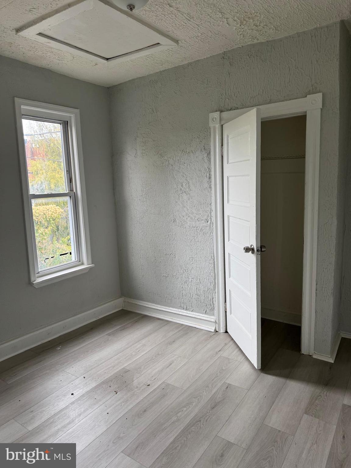 2240 Cedley Street Baltimore, MD 21230 - Photo 8 of 12 an empty room with wooden floor and windows