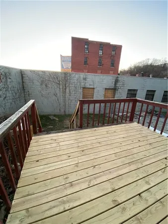a view of a house with backyard and deck