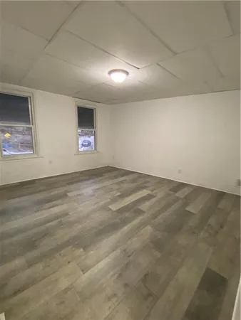 an empty room with windows and closet