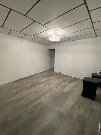a view of a room with wooden floor