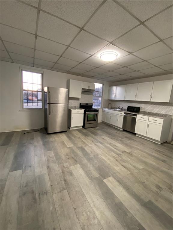 113 Kirkpatrick Street Pittsburgh, PA 15219 - Photo 5 of 29 a view of a kitchen with a fridge and a window