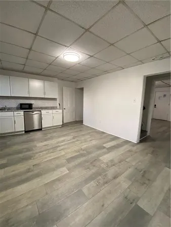 a view of a kitchen with a sink and a refrigerator