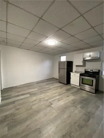 a view of kitchen and refrigerator