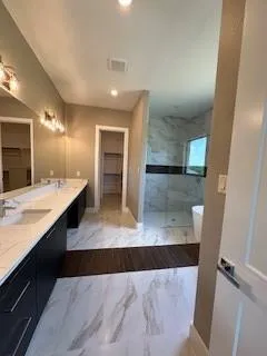 an empty room with windows and a ceiling fan