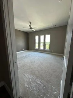 a view of a hallway with wooden floor and a living room