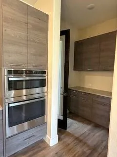 a view of kitchen with kitchen island a sink stainless steel appliances and cabinets
