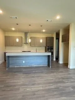 a view of a livingroom with wooden floor and stairs