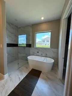 a large bathroom with a large tub and sink