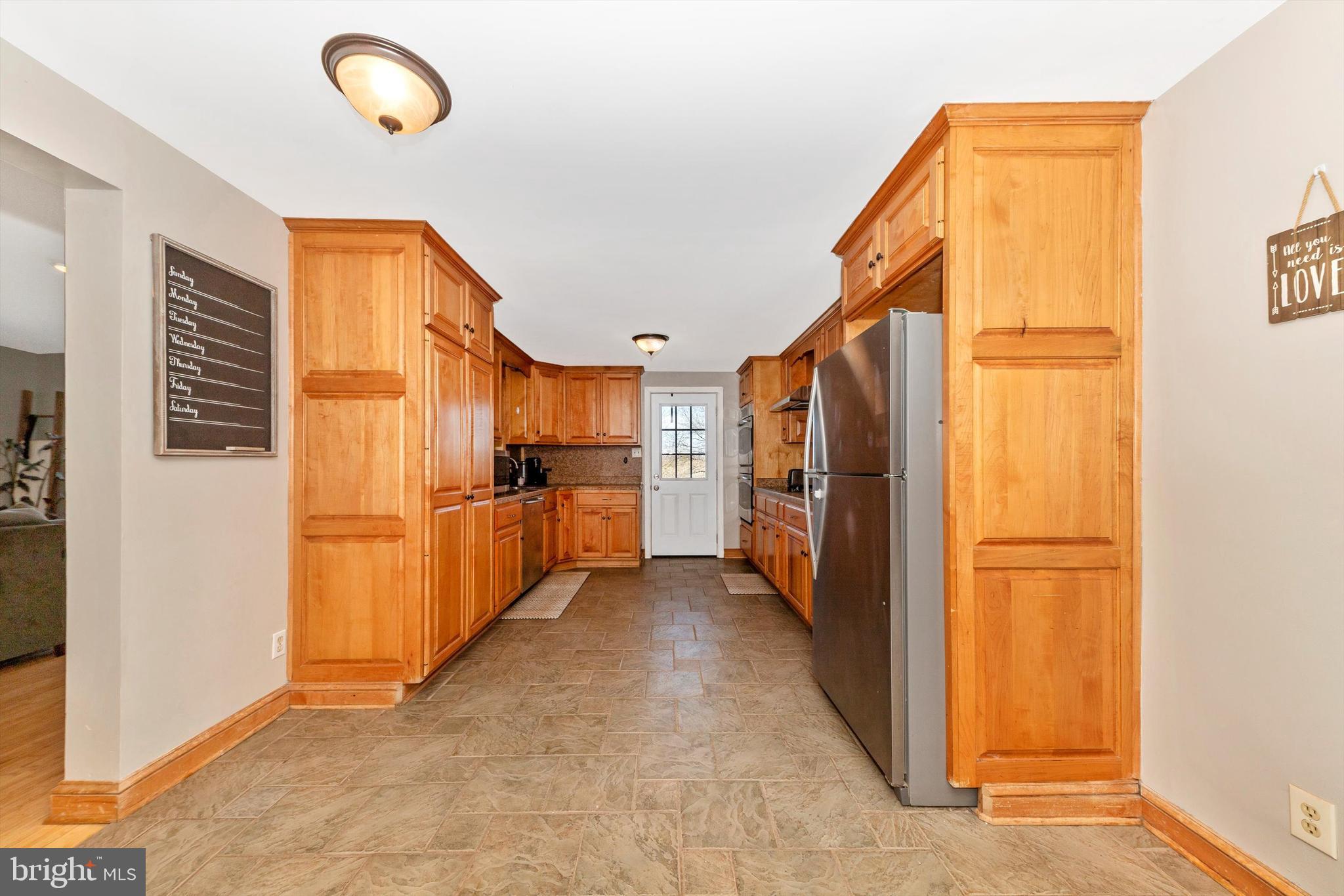 17449 Irishtown Road Emmitsburg, MD 21727 - Photo 5 of 77 a view of a kitchen with a refrigerator and a stove