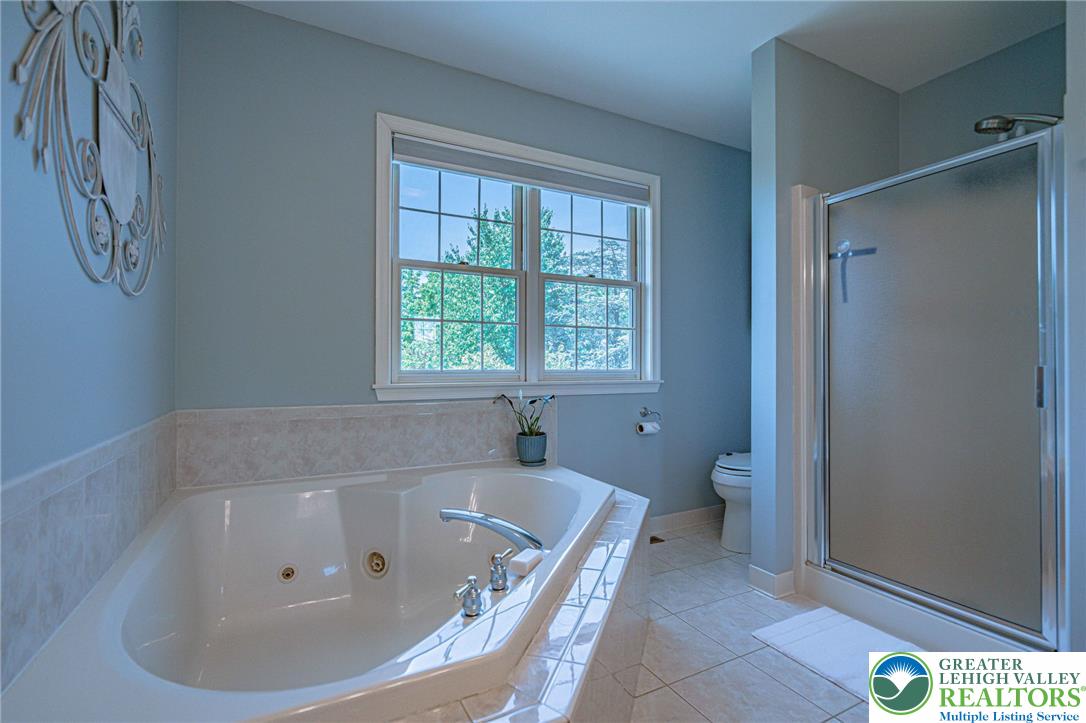 4542 Springfield Drive Coplay, PA 18037 - Photo 43 of 89 Relax in this inviting bath with a soaking tub and views of nature.