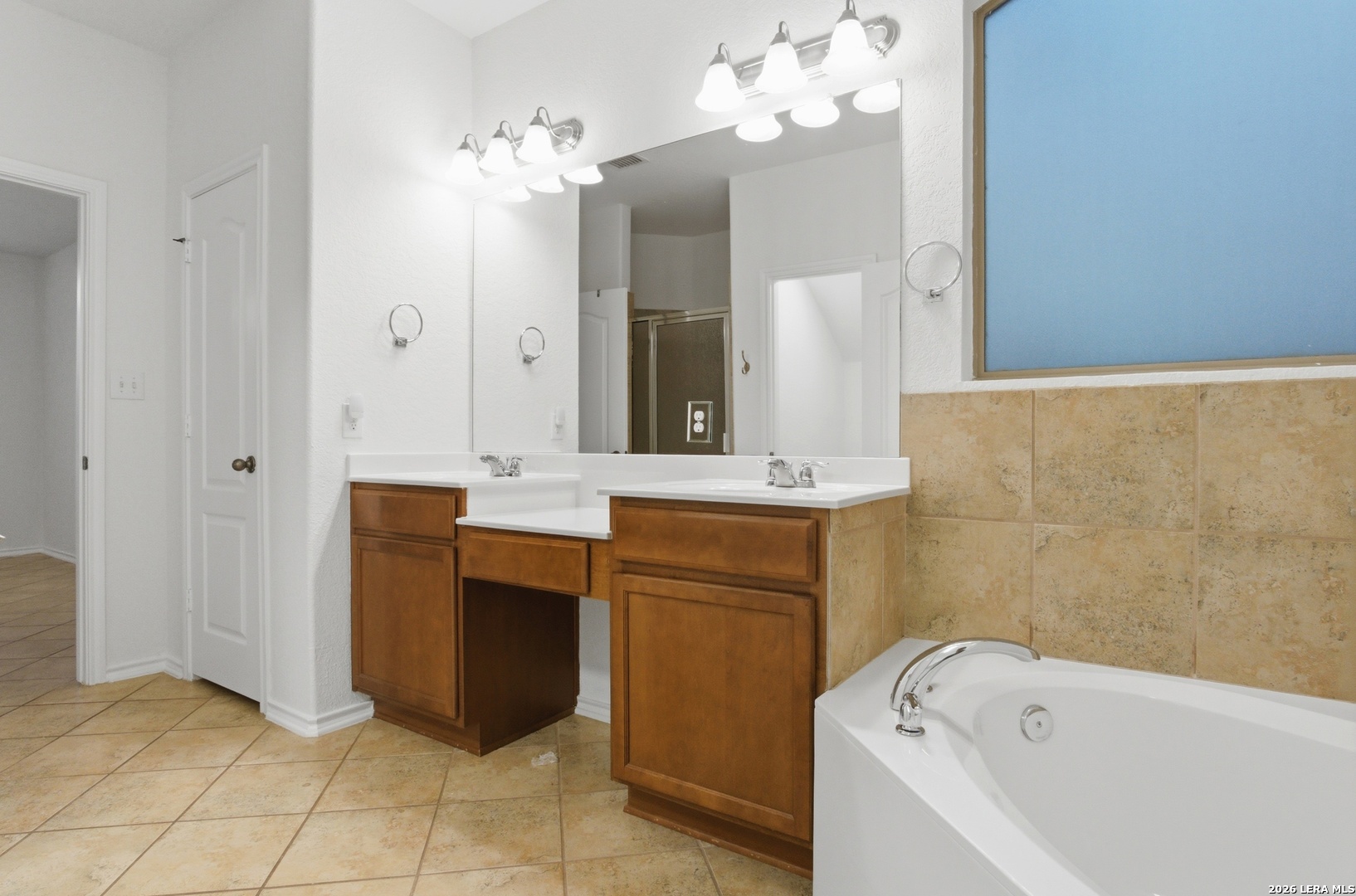 509 Brook Shadow Cibolo, TX 78108 - Photo 15 of 38 a bathroom with a bathtub sink and a mirror