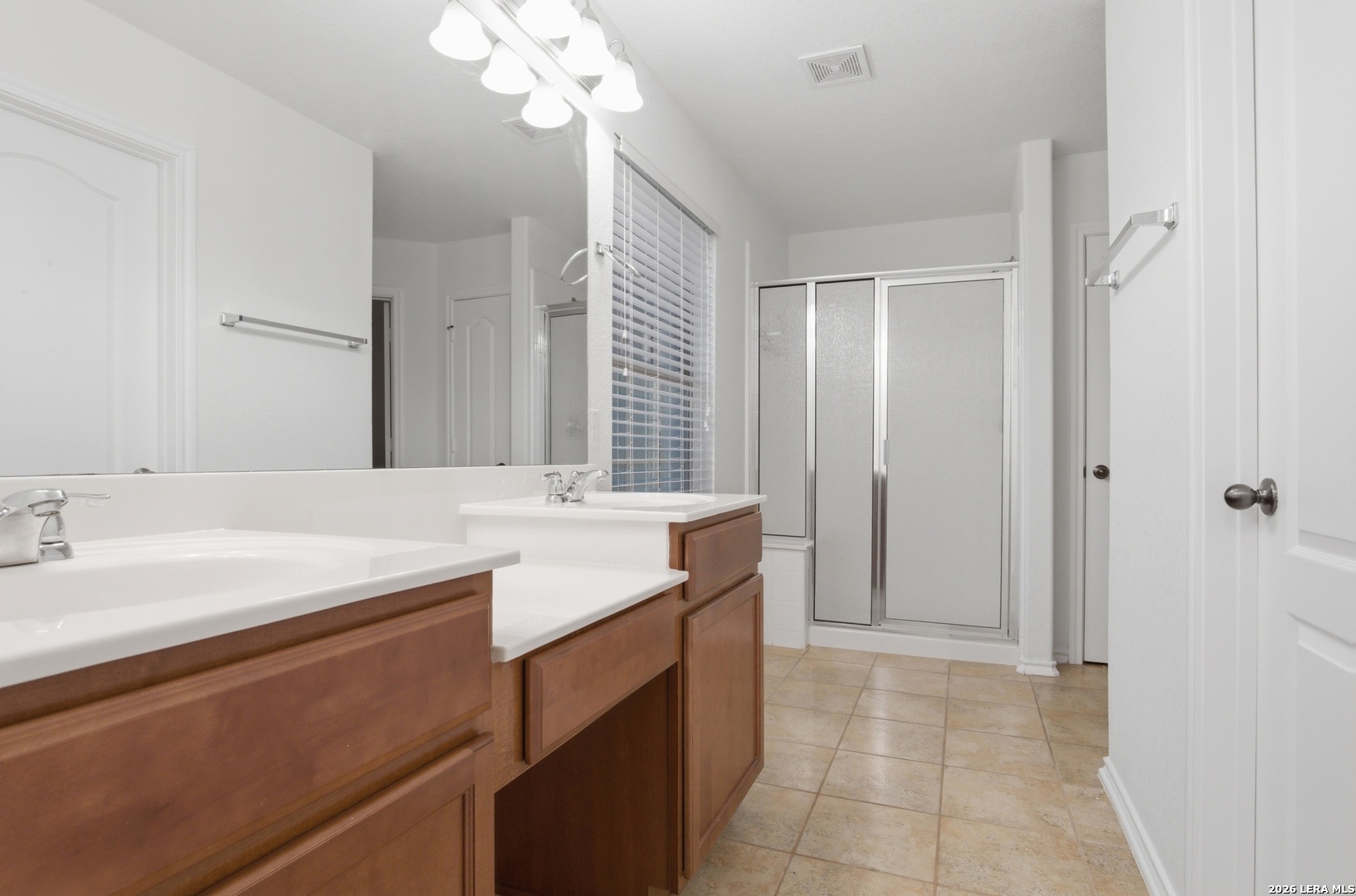 509 Brook Shadow Cibolo, TX 78108 - Photo 23 of 38 a bathroom with a sink a vanity a mirror and a shower