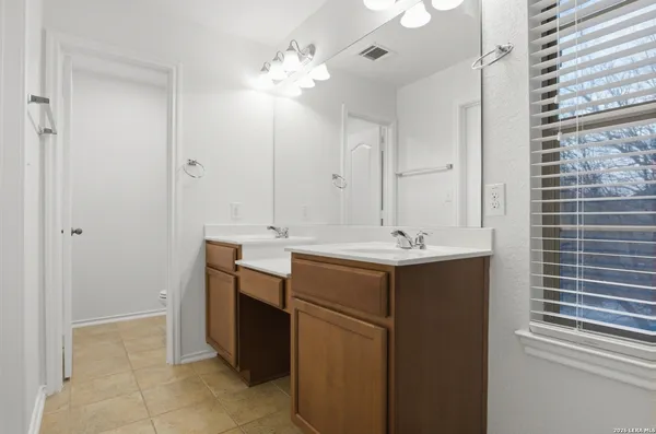 a bathroom with a sink vanity and a mirror