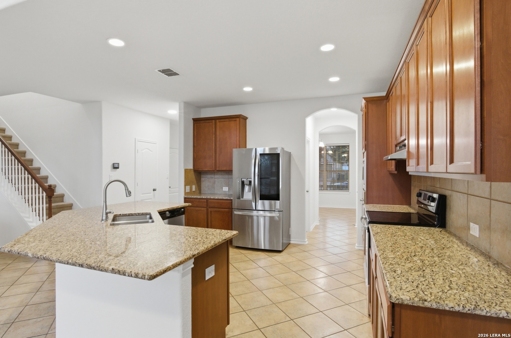 509 Brook Shadow Cibolo, TX 78108 - Photo 10 of 38 a kitchen with stainless steel appliances granite countertop a sink and a refrigerator