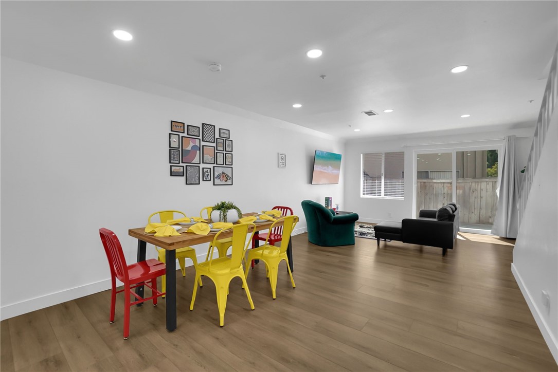 a view of a dining room with furniture and wooden floor
