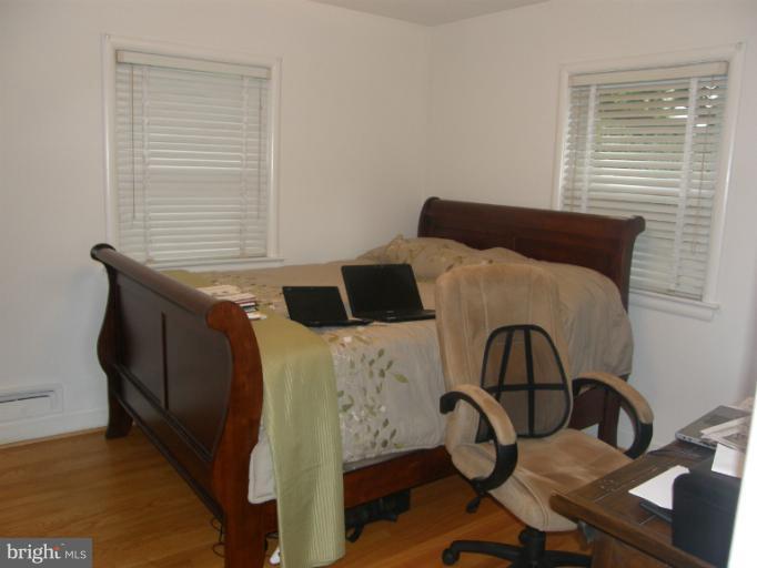 3306 Russell Road Alexandria, VA 22305 - Photo 14 of 21 a bedroom with a bed and wooden floor