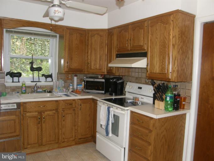 3306 Russell Road Alexandria, VA 22305 - Photo 15 of 21 a kitchen with stainless steel appliances granite countertop a stove a sink dishwasher and a microwave oven with cabinets