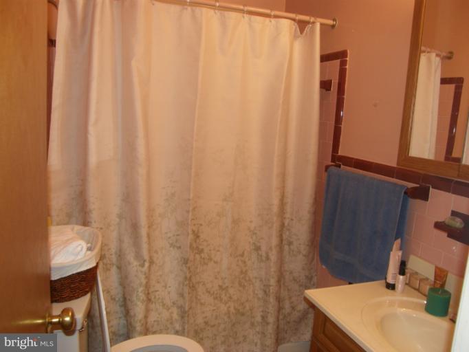 3306 Russell Road Alexandria, VA 22305 - Photo 7 of 21 a bathroom with a sink a toilet and a mirror