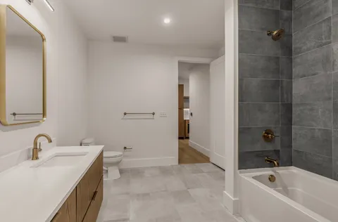 a view of a building with a garden and pathway